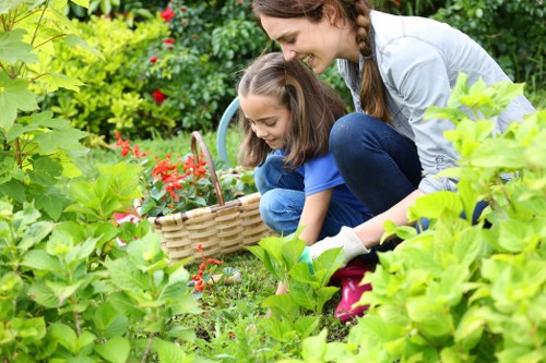 Professional gardeners in Osterley caring for lawn and planting
